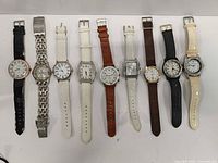 Front view of all nine wristwatches in lot