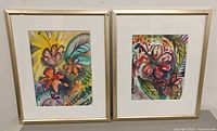 Both framed watercolor paintings side by side