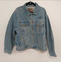 Front view of Armani Jeans denim jacket hanging