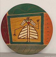 Front view of painted wood plate with abstract design