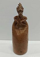 Full view of stoneware monastic figure vessel