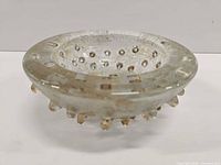 Top oblique view of clear glass bowl showing gold flecks, controlled bubbles and spike detailing
