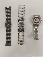 Front view of three silver-tone wristwatches