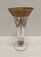 Full view of crystal champagne flute showing shape and gold gilding