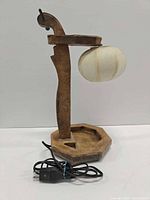 Front view showing full lamp, wood frame, shade, cord