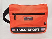 Front view showing Polo Sport branding, front zip pocket and overall color