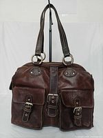 Front view showing overall bag design, front pockets and hardware