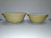 Side view of both bowls showing size comparison and exterior motif