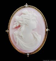 Front view of cameo brooch pendant on black background