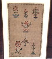 Full view of sampler showing stitched motifs