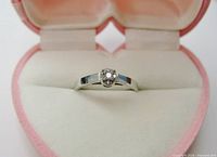 Front view of diamond cluster ring in heart box