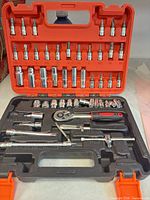 Entire 53-piece set in open orange case showing sockets, bits, ratchet, extensions