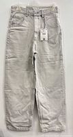 Full view of light grey Bershka jeans hanging, showing front and legs