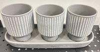 Front view of three ribbed pots on tray