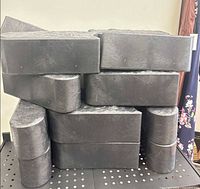 Front view of stacked dark grey rubber pavers