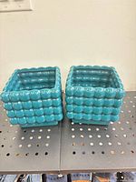 Two aqua square ceramic planters front/side view