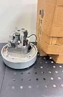 Overall view of the Wolong replacement motor next to its shipping box