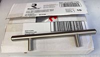 Boxed Richelieu cabinet pull resting on packaging label shows model and specs