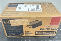 Manufacturer’s sealed carton showing Tork branding and model