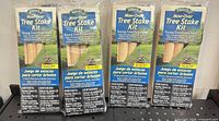 Four sealed Gardener's Blue Ribbon Mow-Over Tree Stake Kits side by side
