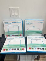 Front view of four sealed scale boxes