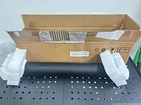 Roller in open cardboard box with foam caps
