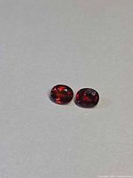 Pair of oval spessartite garnets front view