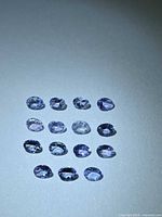 Fifteen oval violet-blue gemstones arranged in 5×3 grid