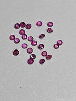 Loose round rubies spread on surface