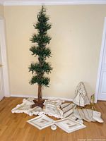 Full view of assembled slim tree with accessories spread at base