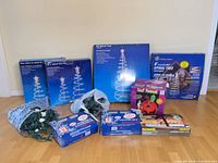 Group shot of all boxed spiral trees, boxed lights, inflatable and loose string lights