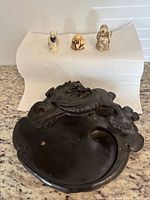 Inkstone and three netsuke on paper towel