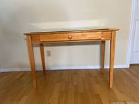 Front view of light cherry desk, glass top visible