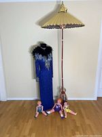 Lot overview with gown on mannequin, parasol, three dolls