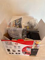Open box showing contents still wrapped inside