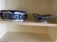 Both blue and white porcelain bowls on shelf