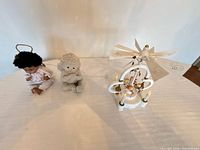 Group shot of cherub figurine, angel doll, and carousel lamp with cord