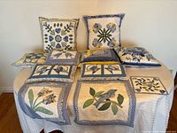 All eleven quilted cotton pieces displayed on table