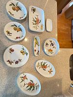 All nine Royal Worcester Evesham pieces displayed on countertop