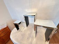All three nesting tables side by side showing relative sizes and mirrored surfaces