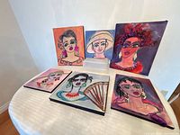 Group shot of all six portrait canvases on a table