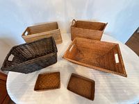 All six wicker baskets arranged on table showing sizes and colours