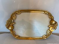 Full view of gilded wooden tray showing fruit clusters and cream center