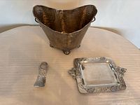 All three hammered metal pieces: ice bucket, tray, bottle holder