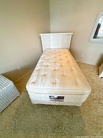 Full view of Simmons twin mattress on bed frame