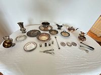 Full layout of all silver-plated pieces on table