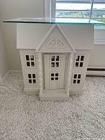 Front view of white dollhouse table with glass top