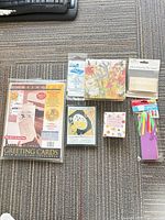 Group shot of all seven packaged items arranged on carpet