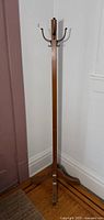 Full view of oak coat rack standing in corner