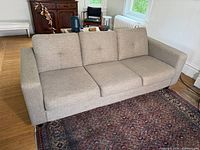 Full view of light grey EQ3 Solo sofa placed on rug